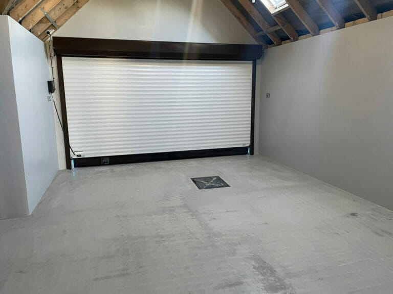 We allowed the floor to dry out for 6 weeks while plastering and painting the walls. Then this Summer we sanded the garage floor to take out some small deformities.