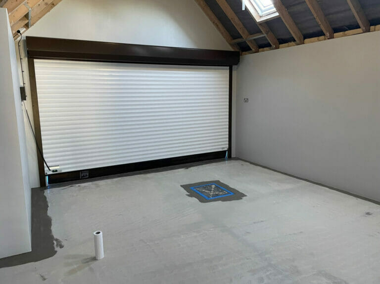 We vacuumed and mopped the floor allowing it to dry over night. Then using a hand drill and paint stirrer we mixed the first tin of primer and used 2” brushes to go around the edges to about 6”.