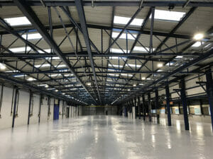Light grey two pack epoxy floor paint top coat applied to a large factory floor