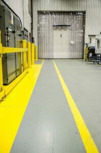 Protection pathway in a manufacturing plant with yellow paint corridor on the floor