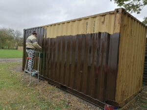 Painting skip with brown container paint