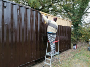 Painting skip with brown container paint