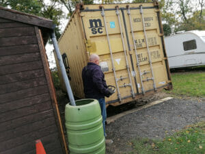 Preparation for painting skip with brown container paint