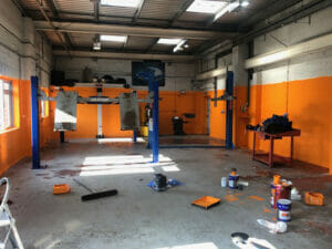Grey two pack epoxy floor paint top coat applied to a working garage floor